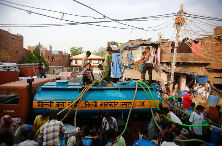 People on truck with hose