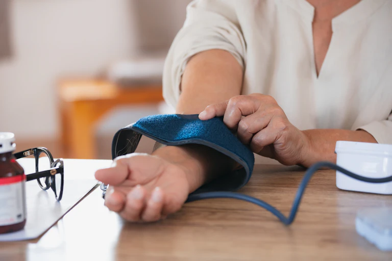 woman take blood pressure test at desk