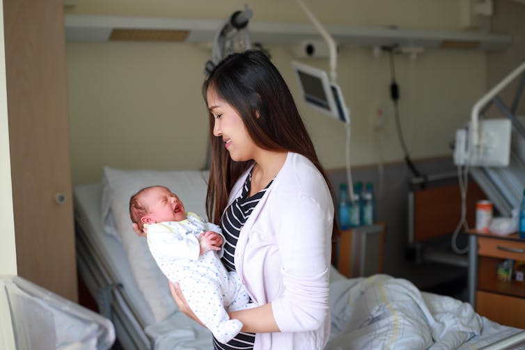 Woman in hospital holding baby