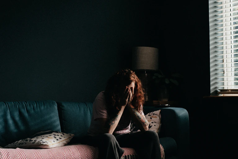 person with head in hands
