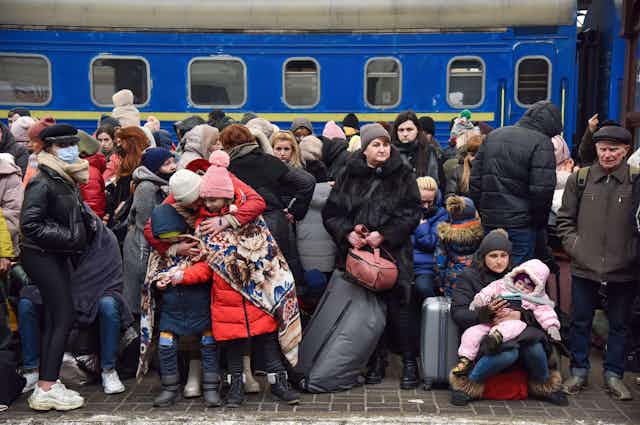 Refugees on the platform of Lviv railway station are seen waiting for trains to Poland