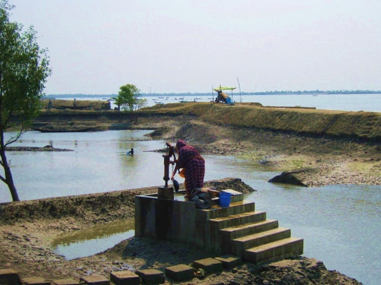 A woman uses a well