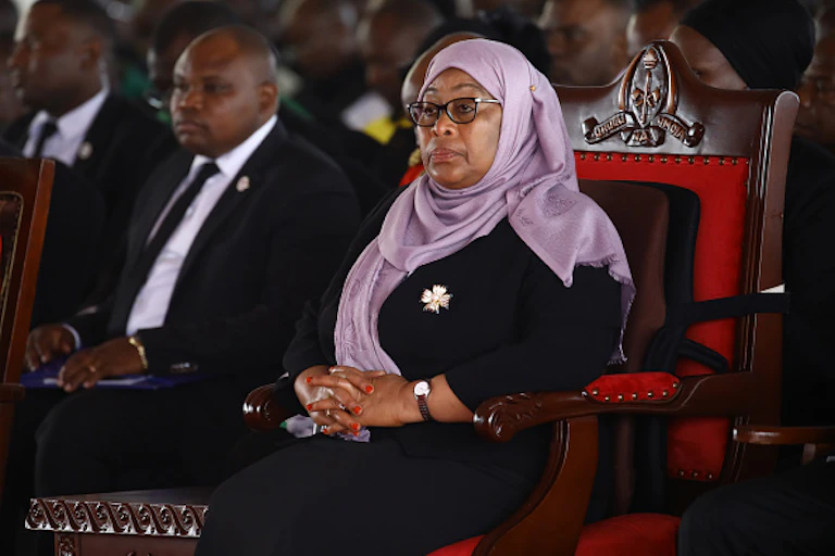 Seated woman wearing spectacles and a hijab
