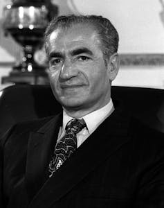 A black and white portrait of the Shah of Iran from the 1970s.