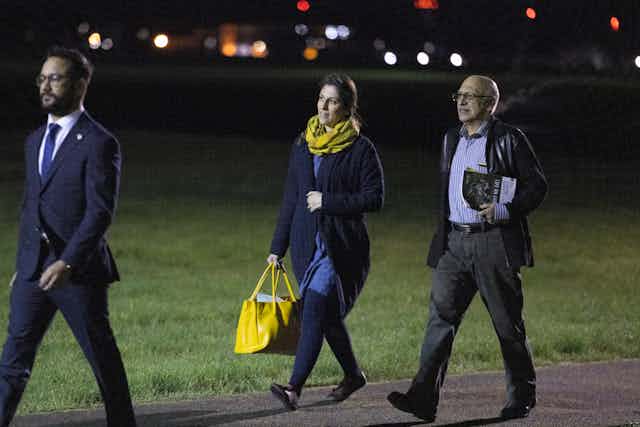 Nazanin Zaghari-Ratcliffe and Anoosheh Ashoori walking along an airport runway at night after arriving from Iran. 