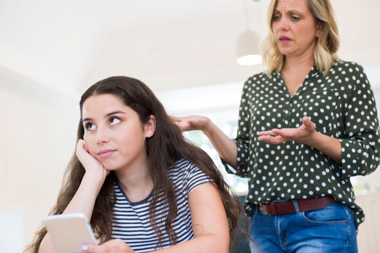 woman talks to teenage girl