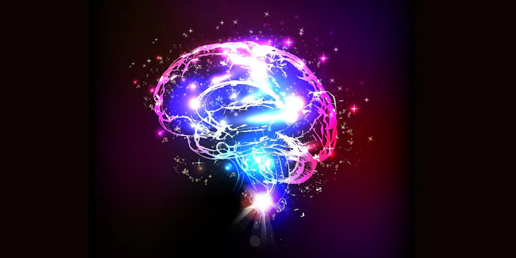 Illustration of a brain lit up with red and blue, against a black background.