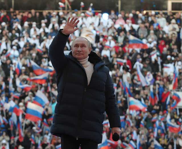 Image of ussian President Vladimir Putin attending a concert marking the 8th anniversary of Crimea's reunification with Russia.