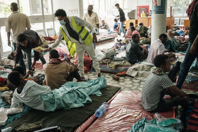 man giving food to people on the floor