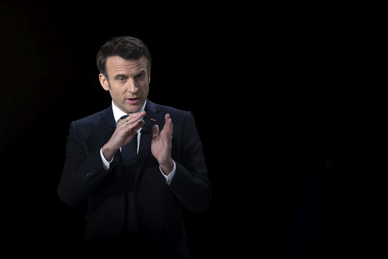 Emmanuel Macron with a black background.