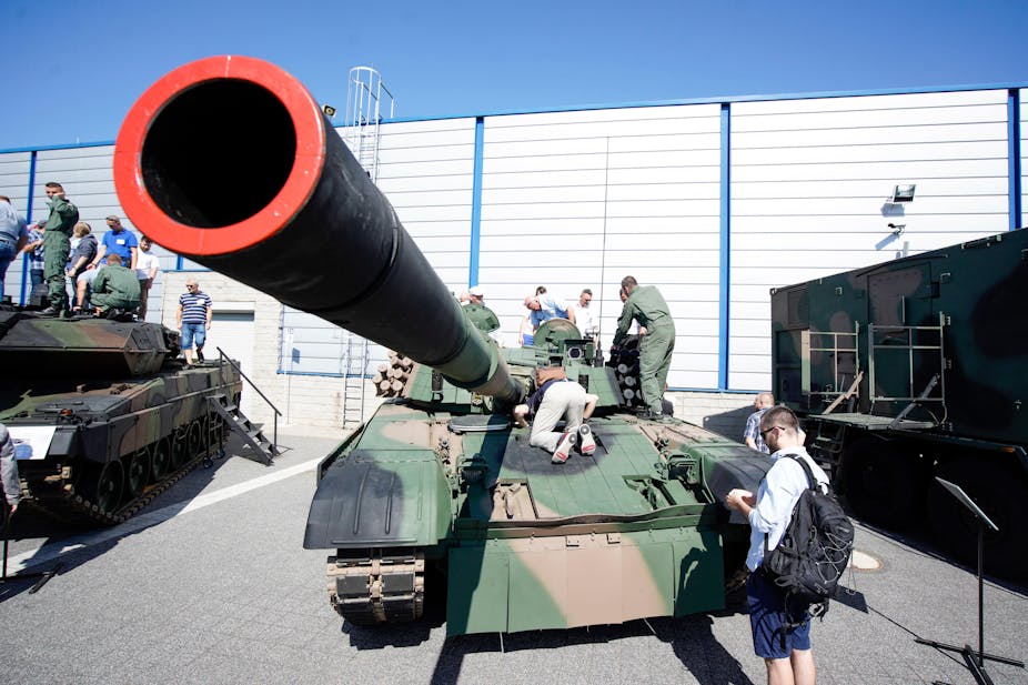 A tank being examined at a Polish arms fair