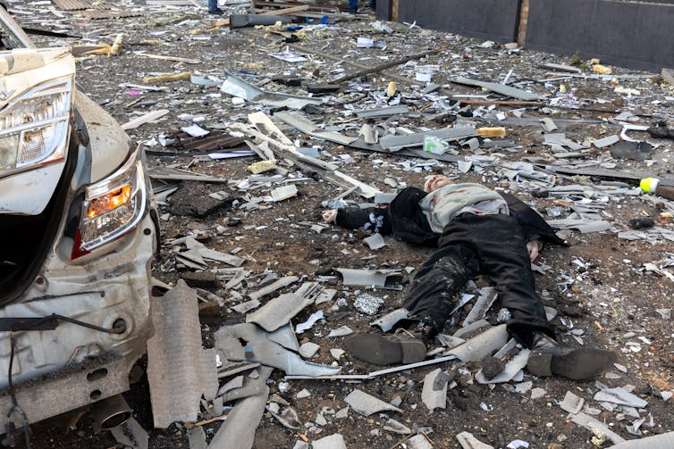 A man's body lies amid rubble in Kyiv, Ukraine.