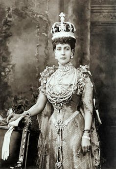 Historical black and white photo of Queen Alexandra wearing an elaborately bejewelled crown.