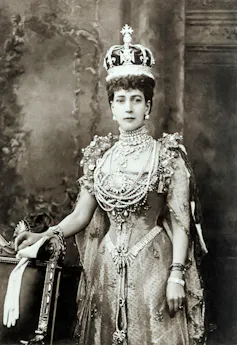 Historical black and white photo of Queen Alexandra wearing an elaborately bejewelled crown.