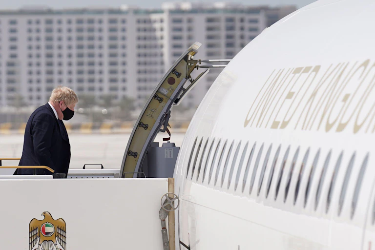 Boris Johnson walking towards a plane entrance on way to Saudi Arabia.