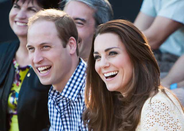 The Duke and Duchess of Cambridge smile while looking away from the camera