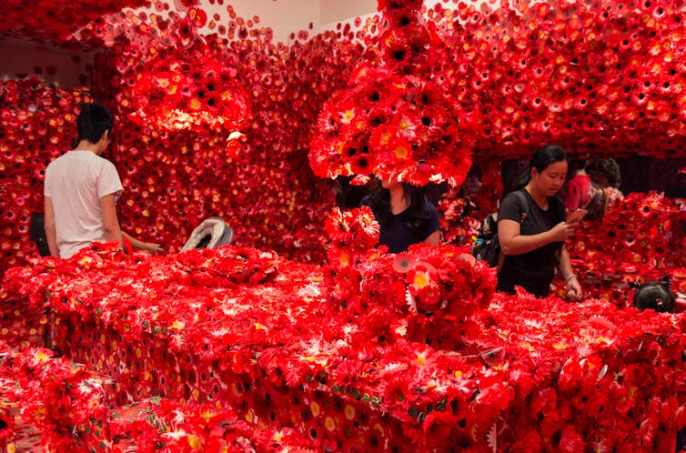 An art gallery filled with red poppies