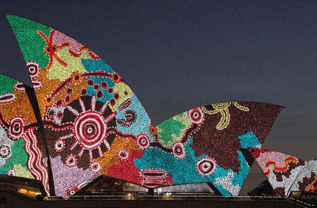 Artwork by Pitjantjatjara man Yadjidta David Miller is projected onto the sails of the Sydney Opera House at dawn