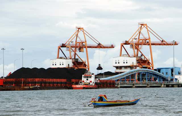 Coal to fuel a power plant in Jeneponto, South Sulawesi, is being unloaded.