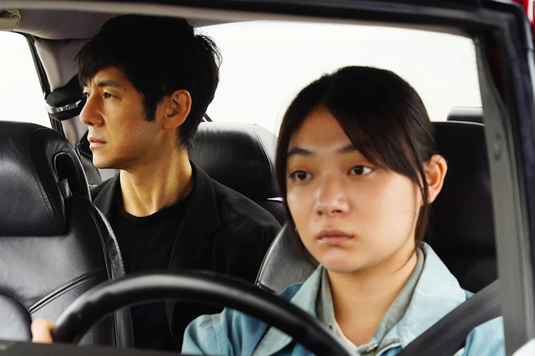Woman drives a man in a car.