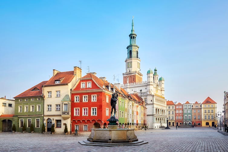 A wide-angle view of a market square in an historic Eastern European city centre.