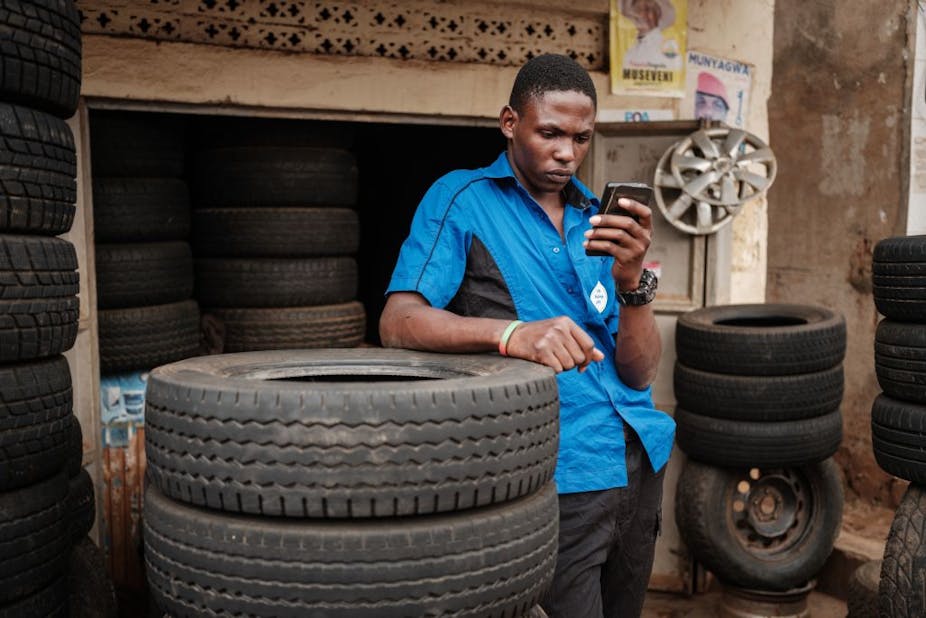 A man browses Facebook on his smart phone after the mobile internet went back online in Kampala, Uganda
