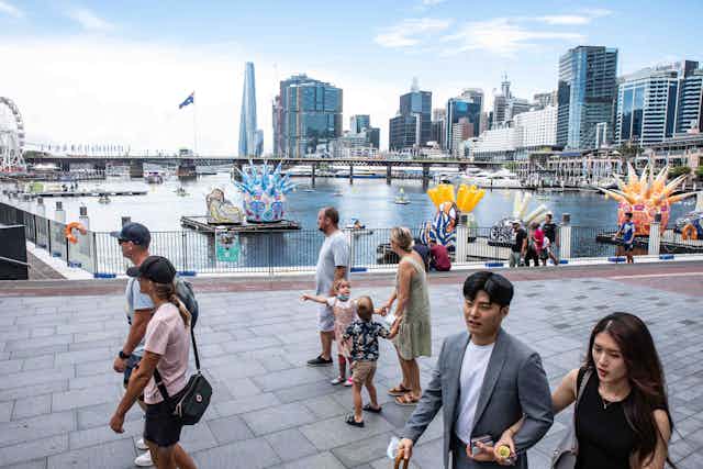 People walk through Darling Harbour, Sydney, 