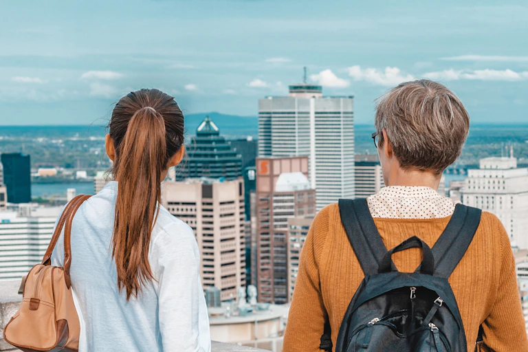 a young man and a woman gaze at an urban skyline