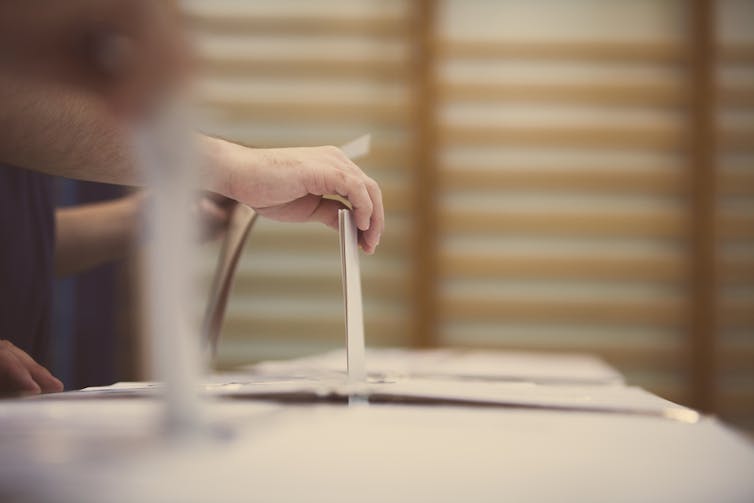 Person voting at the ballot box