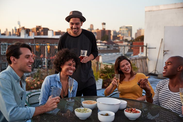 A group of people socialising outdoors.