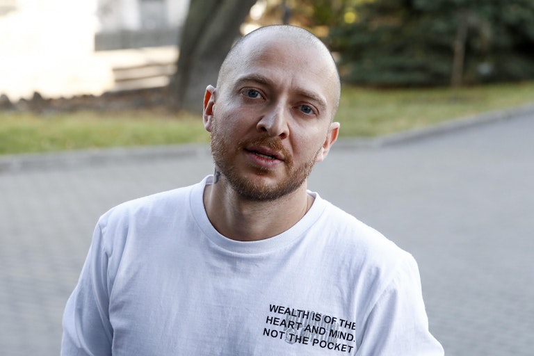 Bald man in white t-short