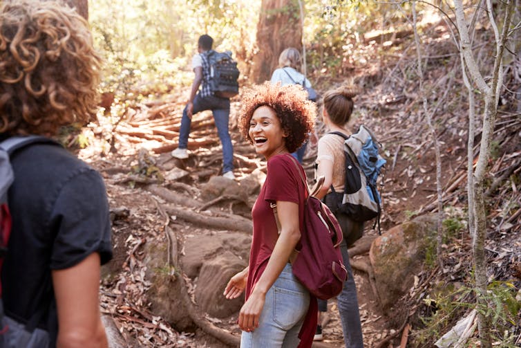 A group of young people go for a hike together.