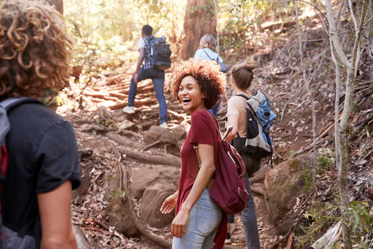 A group of young people go for a hike together.