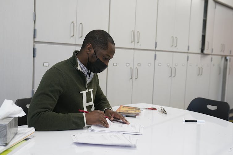 A person sits at a desk reviewing papers