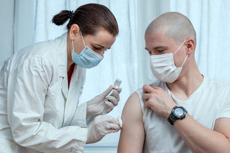 Health care provider preparing to give a patient a shot.