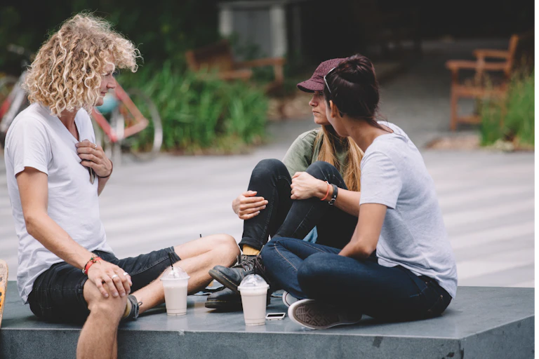 Students sit together outside