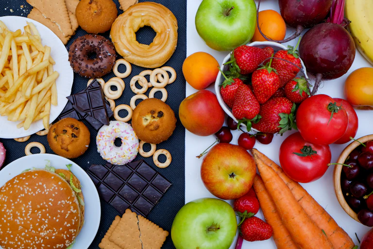 Healthy foods and junk foods laid on a table side by side