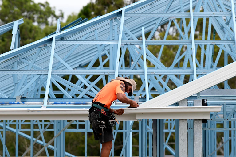 Roofer working on house being built.