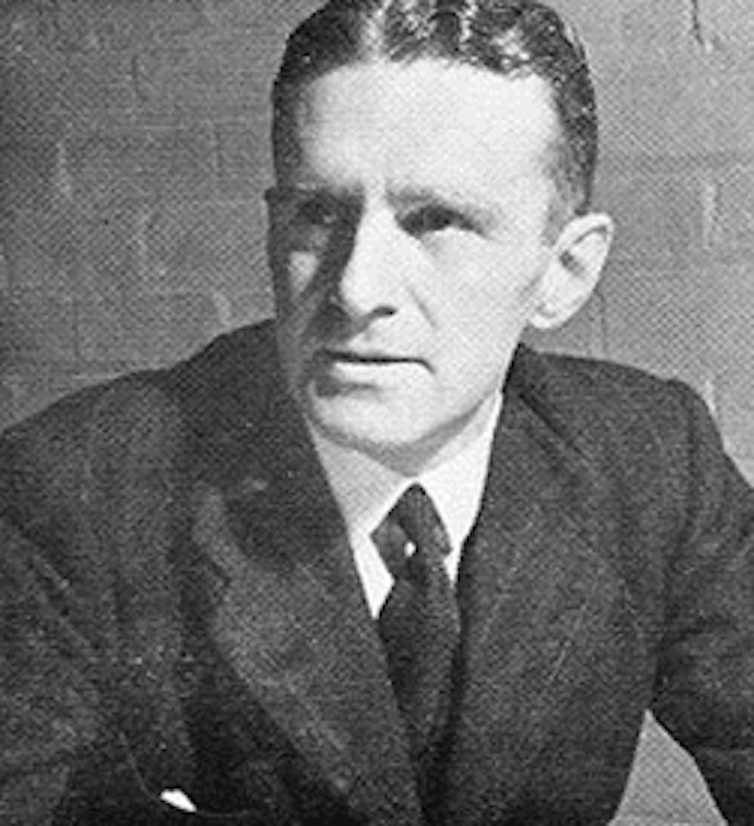 Black and white image of a man in suit.