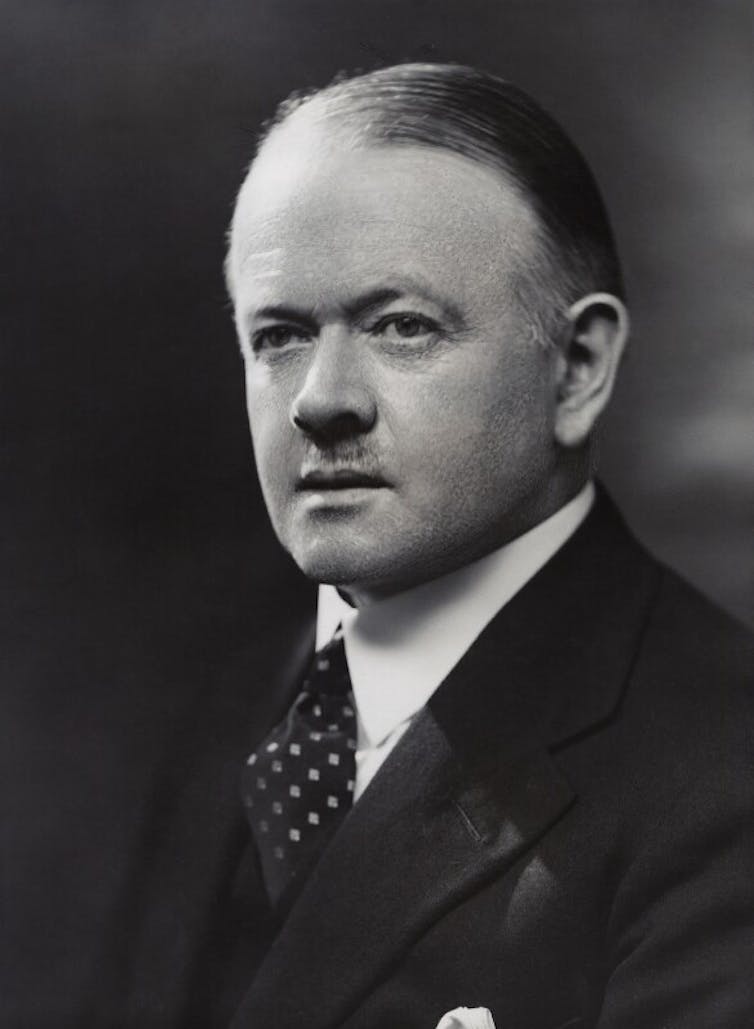Portrait image of a man in a suit.