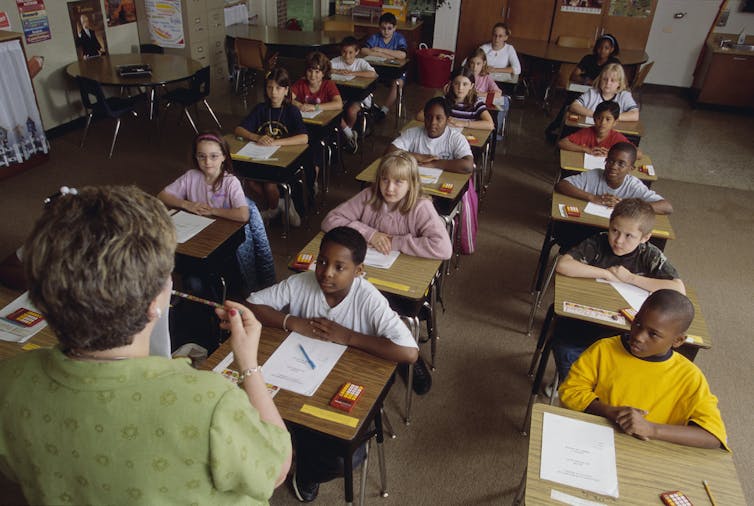 A classroom filled with many children of color.