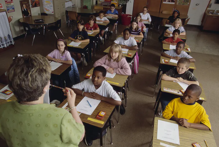 A classroom filled with many children of color.