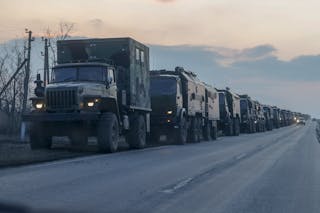 Dozens of trucks with Russian military supplies are seen on a highway.