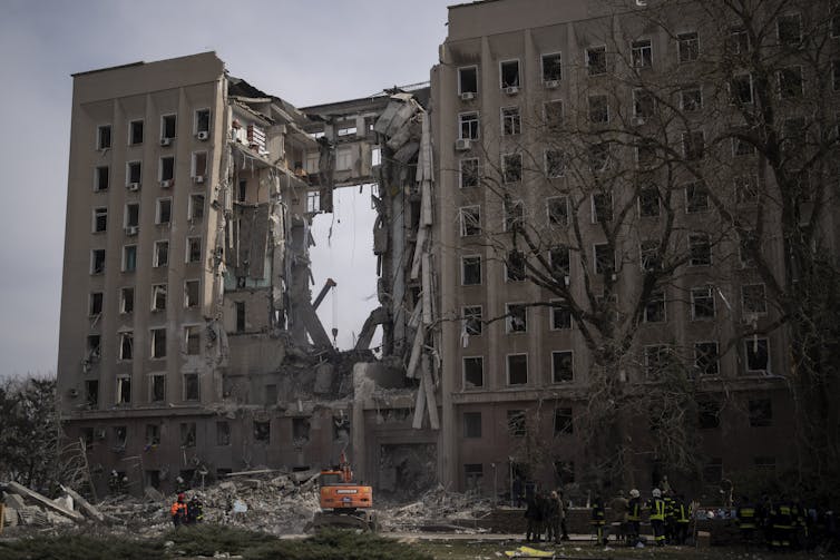 A large multi-storey building with a large hole in the middle of it.