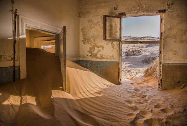 An abandoned house filled with sand