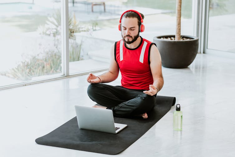 Man meditating with headphones on