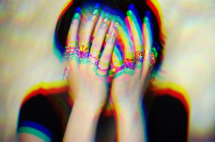 Woman covering her face with her hands and a blurred effect