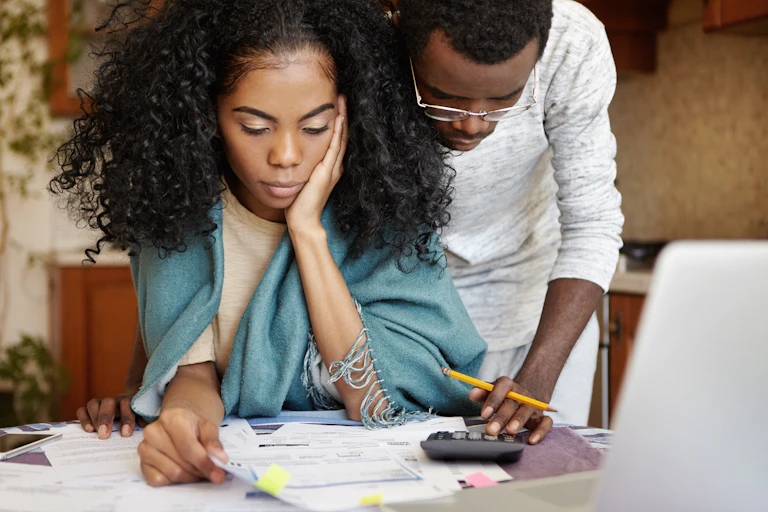 Man and woman looking at bills