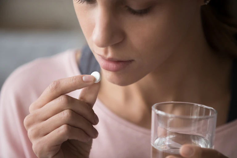 Woman taking a pill