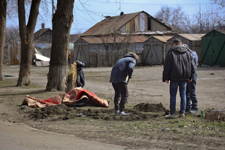 People dig a hole in the ground.